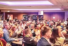 Large audience attending The Running Conference 2026, with engaged participants and event banners in the background.